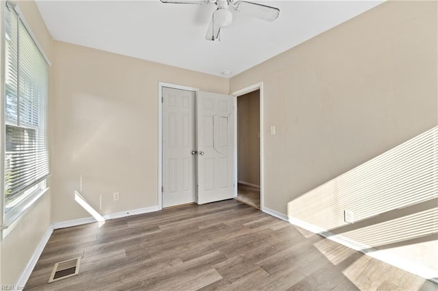 spare room with ceiling fan and wood-type flooring