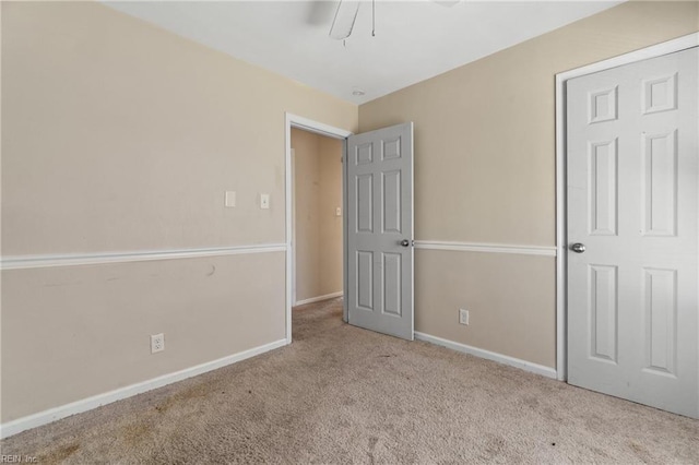 unfurnished bedroom with light carpet and ceiling fan