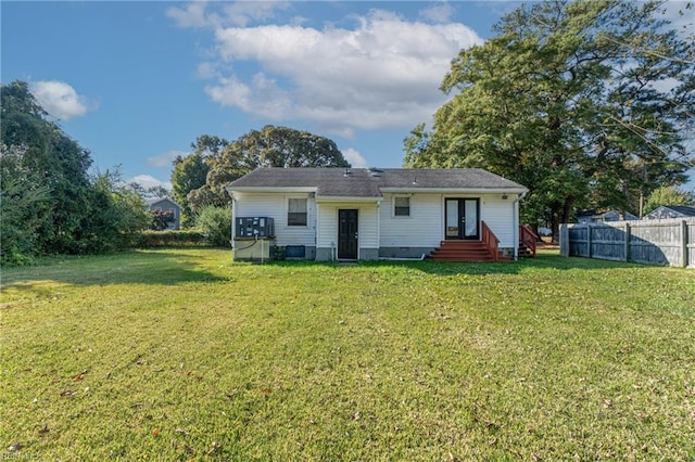 back of house featuring a lawn