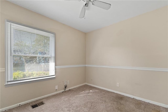 carpeted empty room featuring ceiling fan