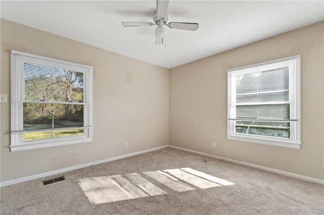 spare room with light carpet and ceiling fan