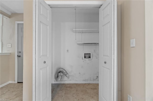 clothes washing area featuring hookup for a washing machine and light tile patterned floors