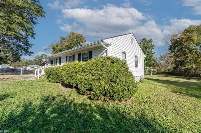 view of home's exterior with a lawn