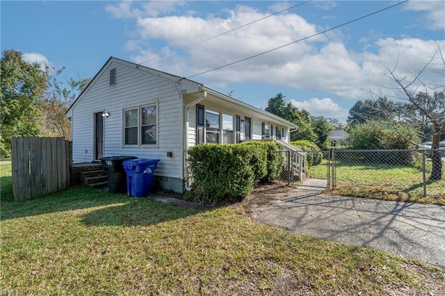 view of side of home with a yard