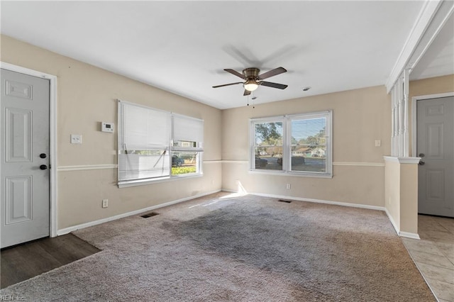 carpeted foyer featuring ceiling fan