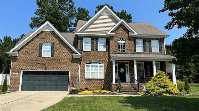 view of front facade featuring a front yard, a porch, and a garage