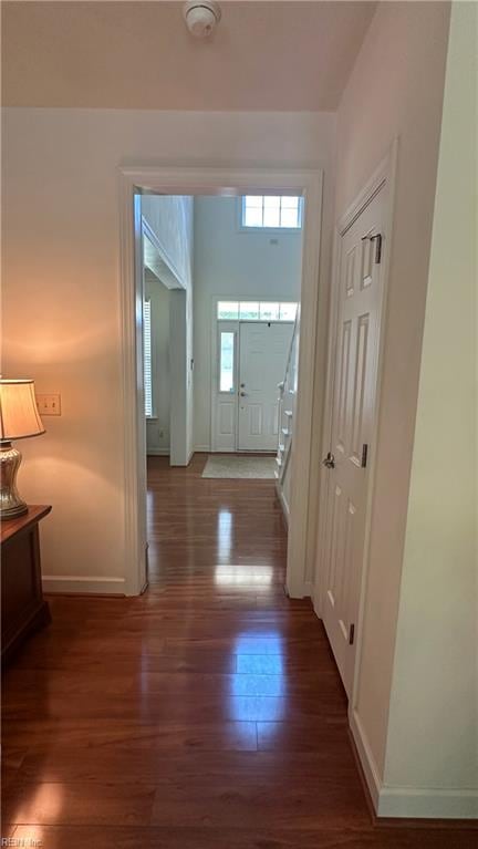 corridor with dark hardwood / wood-style floors