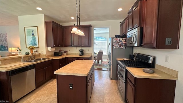 kitchen with hanging light fixtures, light tile patterned floors, a kitchen island, sink, and stainless steel appliances