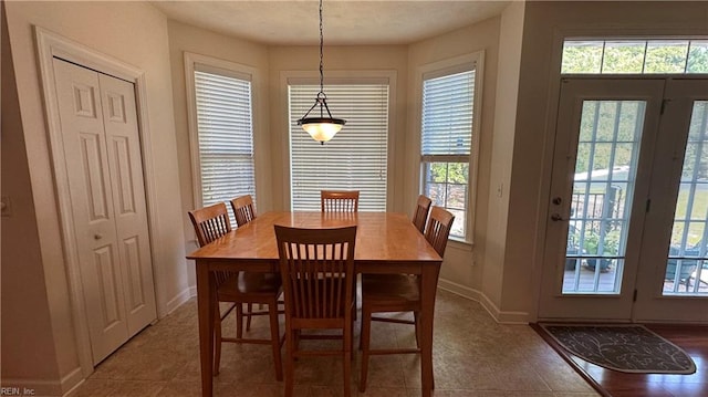 dining space with a healthy amount of sunlight and tile patterned floors