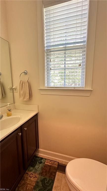 bathroom featuring vanity, toilet, and tile patterned flooring