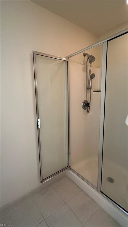 bathroom featuring tile patterned floors and an enclosed shower