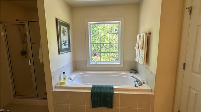 bathroom featuring shower with separate bathtub