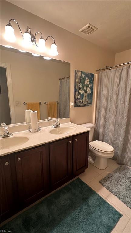 bathroom featuring vanity, toilet, and tile patterned floors