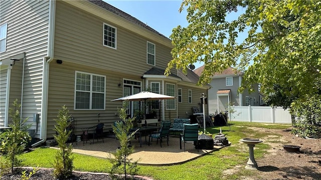 rear view of house featuring a patio and a lawn