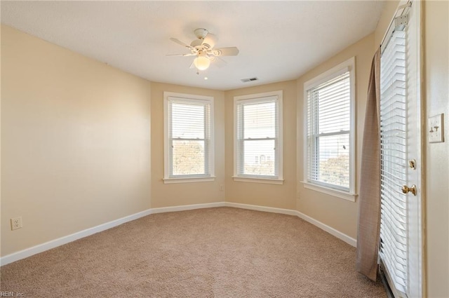 unfurnished room with ceiling fan and light colored carpet