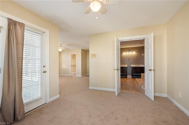 spare room featuring light colored carpet and ceiling fan