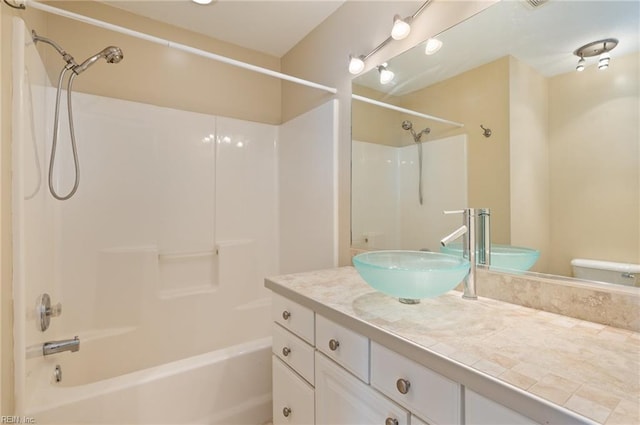 full bathroom featuring bathtub / shower combination, vanity, and toilet