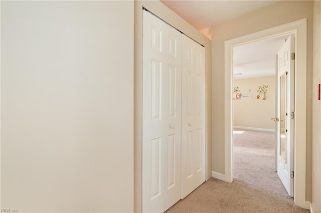 corridor featuring light colored carpet