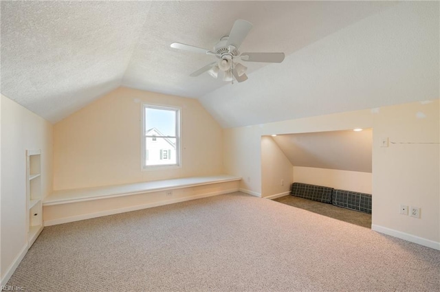 bonus room featuring carpet floors, a textured ceiling, and vaulted ceiling