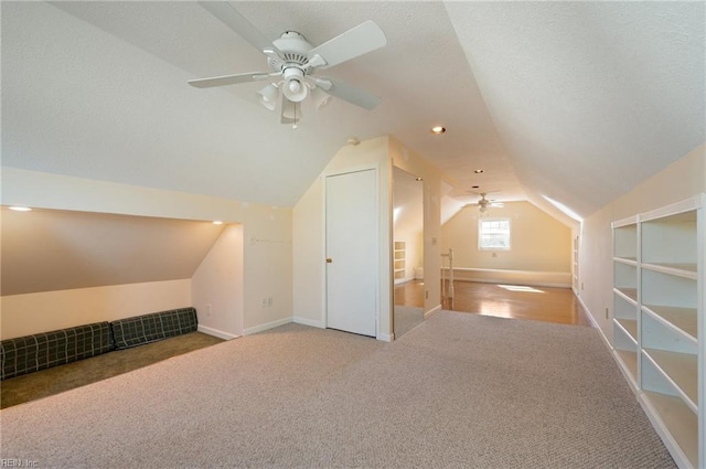 bonus room with ceiling fan, carpet, and vaulted ceiling