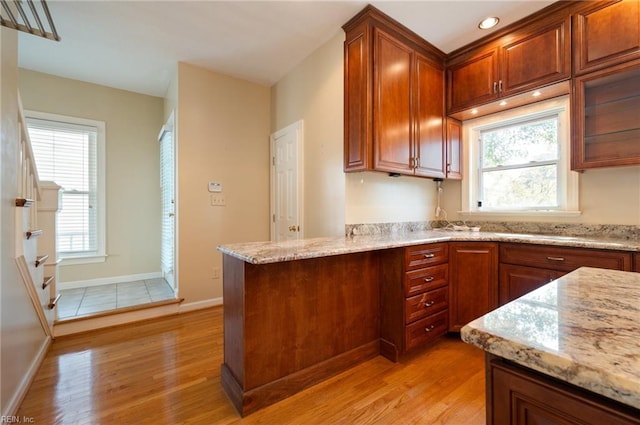 kitchen featuring light hardwood / wood-style flooring and light stone countertops