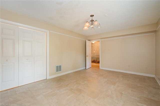 interior space with a notable chandelier and a closet