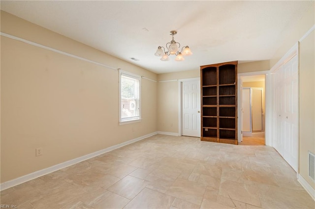 empty room with a notable chandelier