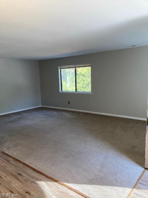 spare room with wood-type flooring