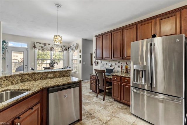 kitchen featuring decorative backsplash, stainless steel appliances, decorative light fixtures, a chandelier, and light stone counters