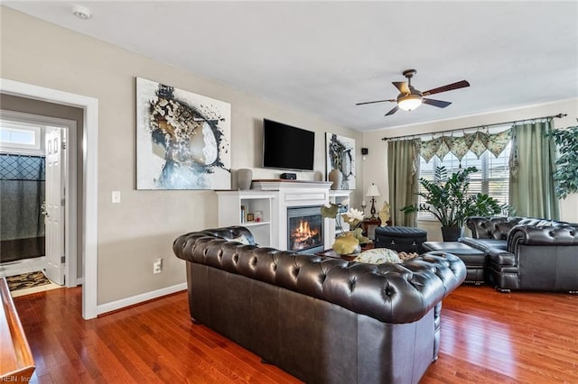 living room with hardwood / wood-style flooring and ceiling fan