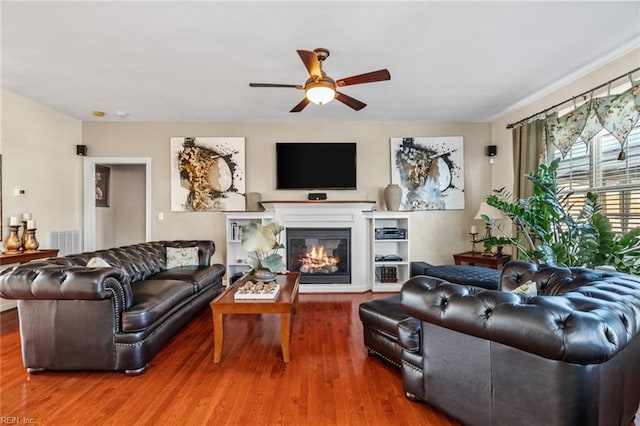 living room with ceiling fan and hardwood / wood-style flooring