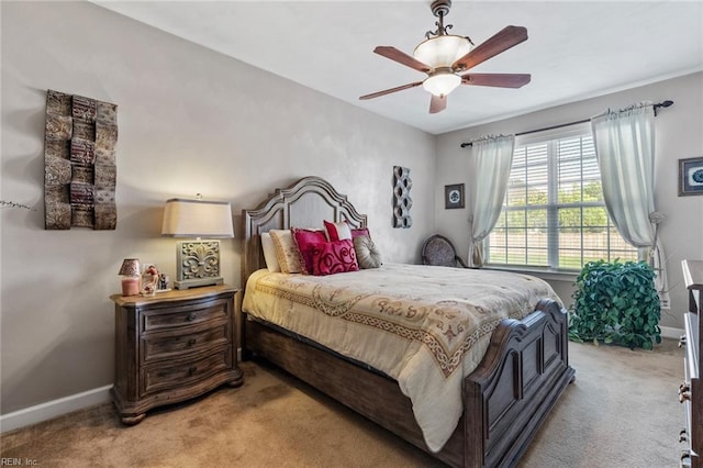 bedroom featuring ceiling fan and light carpet