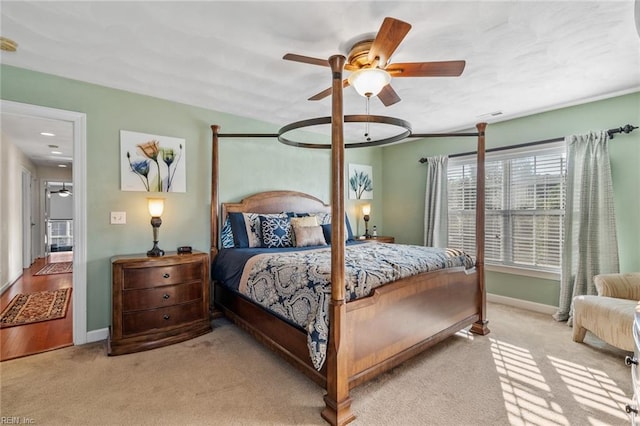 bedroom featuring light colored carpet and ceiling fan