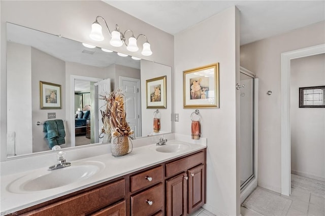 bathroom featuring vanity, an enclosed shower, and tile patterned floors