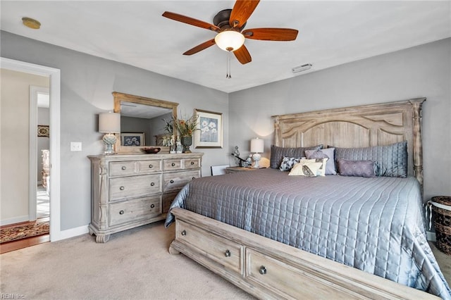 bedroom with light carpet and ceiling fan