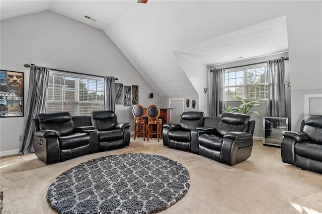 carpeted living room featuring plenty of natural light and vaulted ceiling