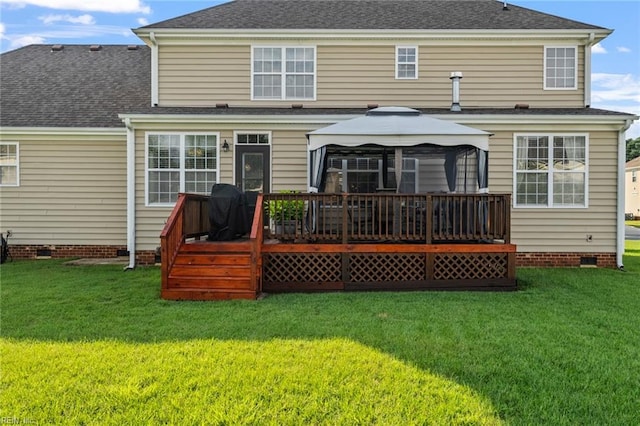 back of property featuring a gazebo, a yard, and a deck