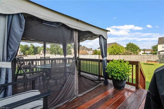 wooden deck with a yard and a gazebo