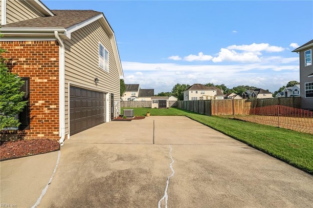 view of home's exterior with a lawn, central AC unit, and a garage