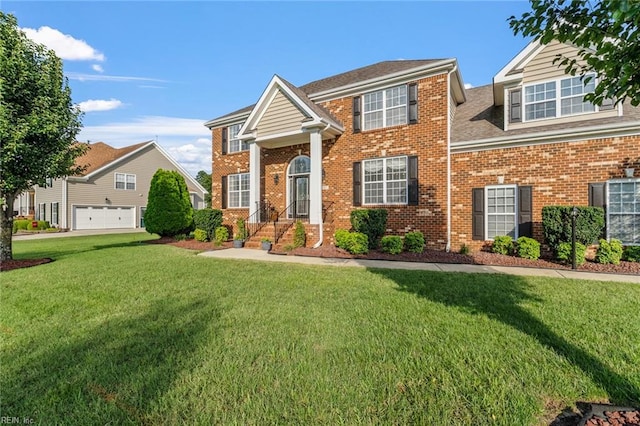 view of front of property featuring a front lawn and a garage