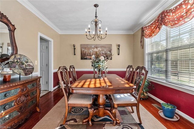 dining area featuring crown molding, hardwood / wood-style flooring, and plenty of natural light