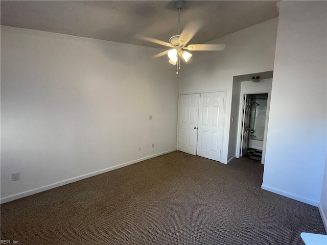 unfurnished bedroom with ceiling fan and dark colored carpet