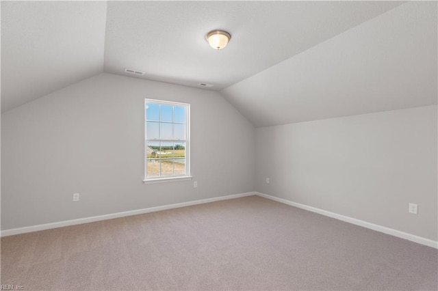 bonus room featuring lofted ceiling and carpet floors