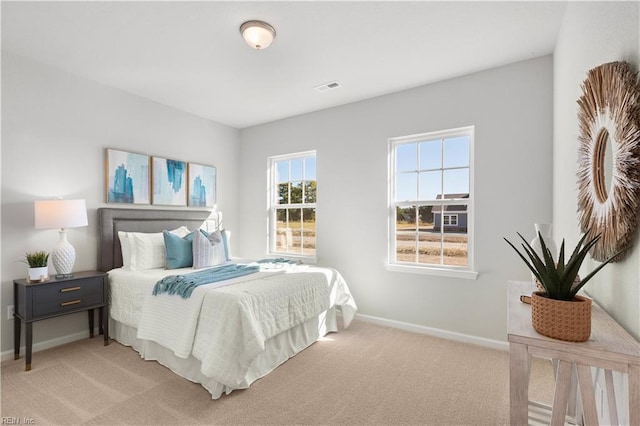 bedroom featuring light carpet