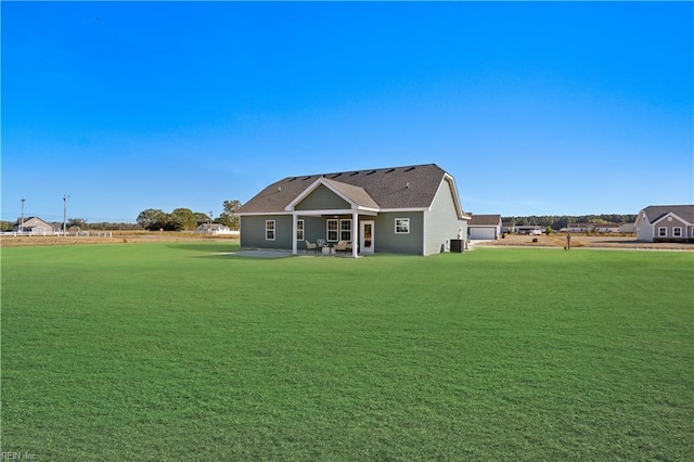 rear view of property featuring a patio area and a lawn