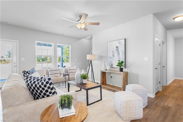 living room featuring hardwood / wood-style floors and ceiling fan