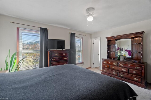 bedroom with light colored carpet and ceiling fan