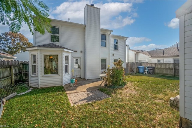 rear view of property with a lawn