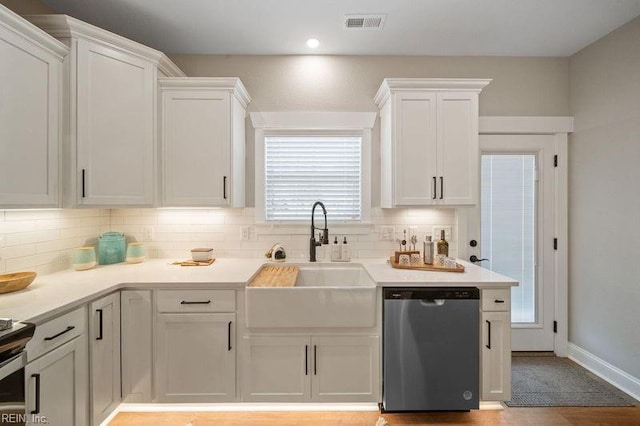 kitchen featuring white cabinets, stainless steel appliances, sink, and backsplash