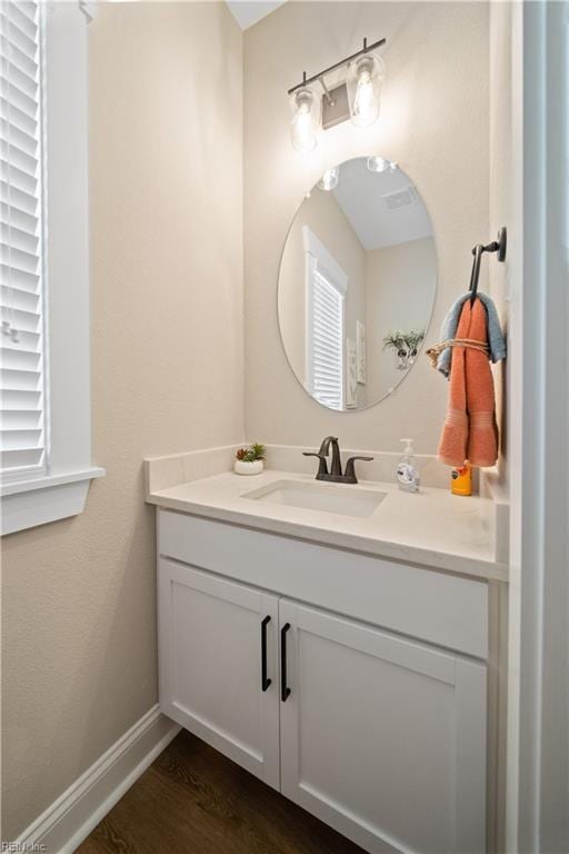 bathroom featuring vanity and hardwood / wood-style floors